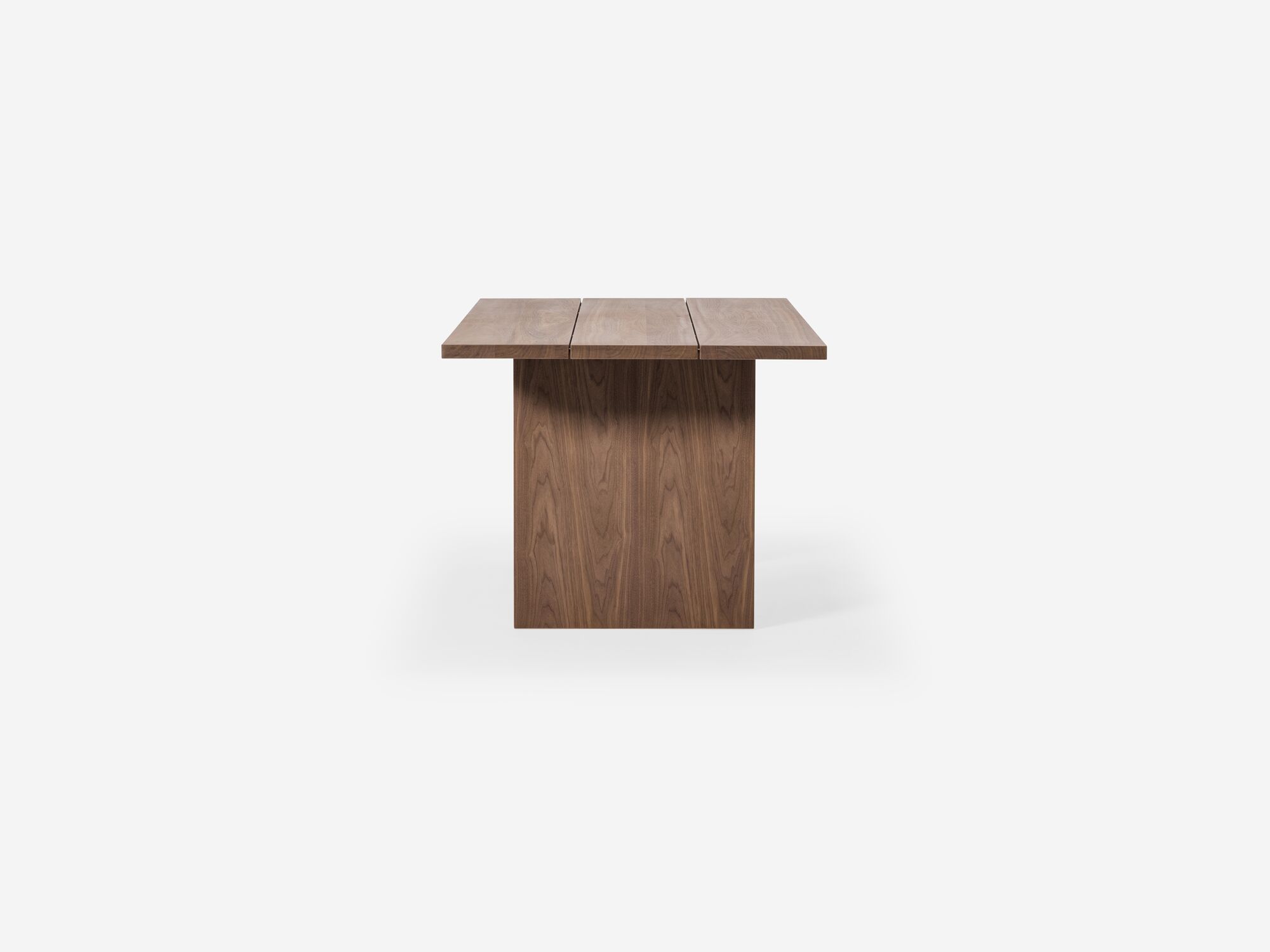 Side view of walnut dining table with two legs